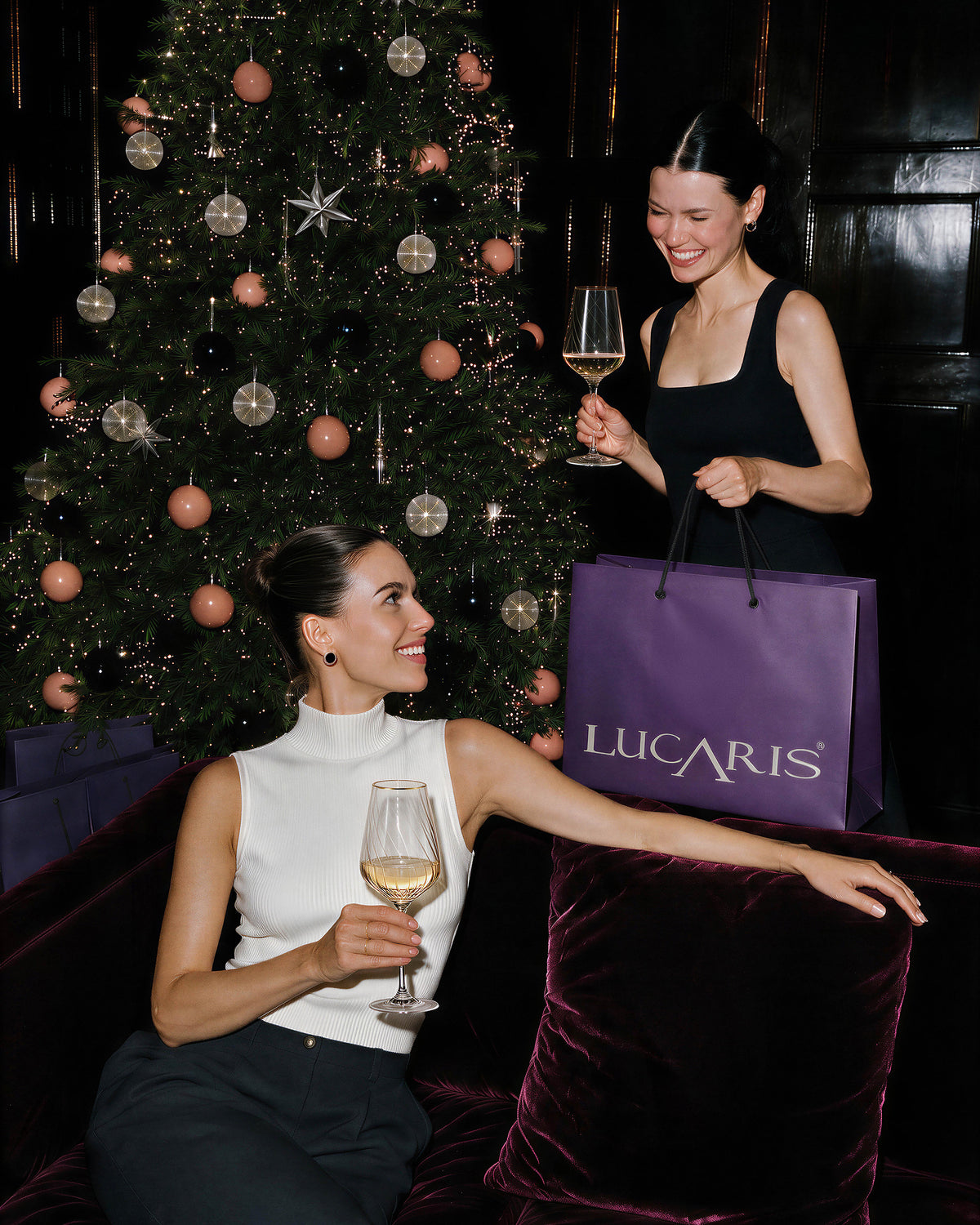 LUCARIS crystal Chardonnay glasses at a festive gathering by a Christmas tree
