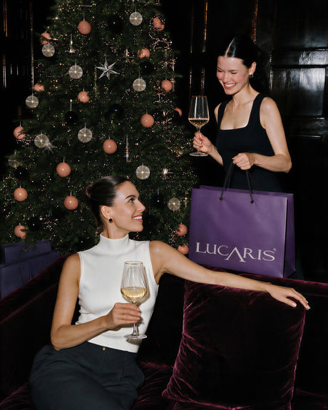 LUCARIS crystal Chardonnay glasses at a festive gathering by a Christmas tree