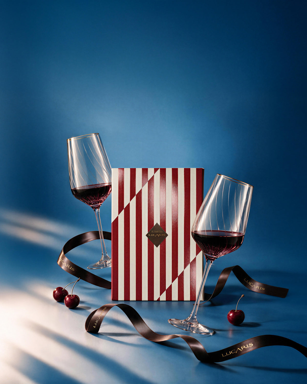 LUCARIS Holiday Atelier Signature Bordeaux Set: two crystal Bordeaux glasses with the red striped gift box